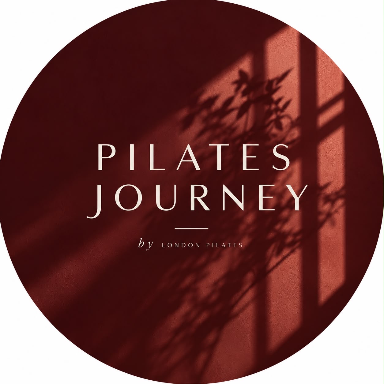 Pilates Journey wordmark on a sunlit burgundy wall